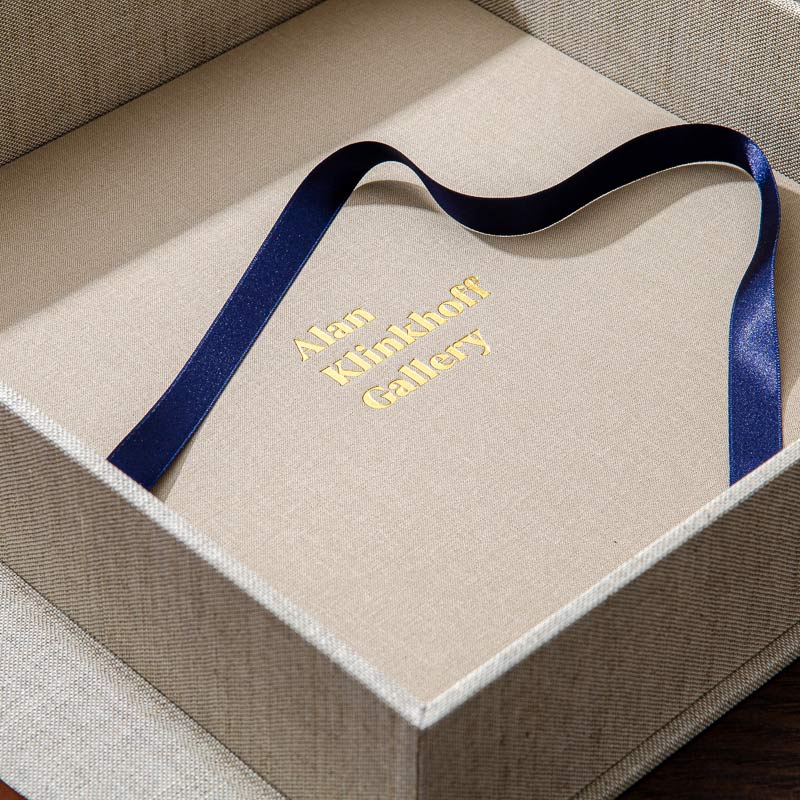 custom made clamshell box with blue ribbon and gold foiled logo embossed into the cover - Gallery image 3