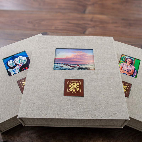 custom made luxury clamshell presentation boxes personalised with pictures inset into the cover and gold embossed logos 