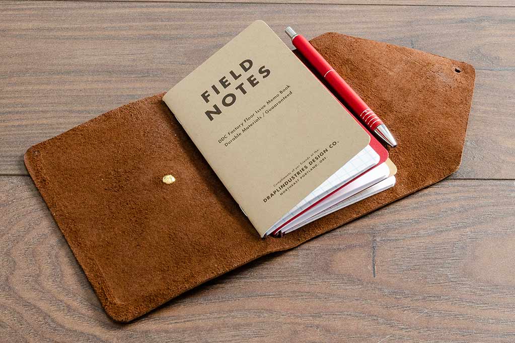 Leather Notebook Cover Holding Three A6 Field Notebooks and a Pen