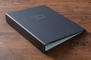 Personalised case bound portfolio book in charcoal buckram.