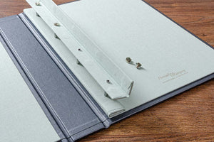 To put pages into the portfolio or to take them out, lift over the magnetic cover and simply undo the screw heads.
