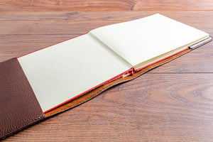 The book or log book fits snuggly into hand stitched pockets