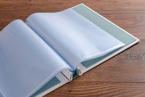The custom screw post binder holds the page protectors firmly at the edge so that the pages turn like a bound book